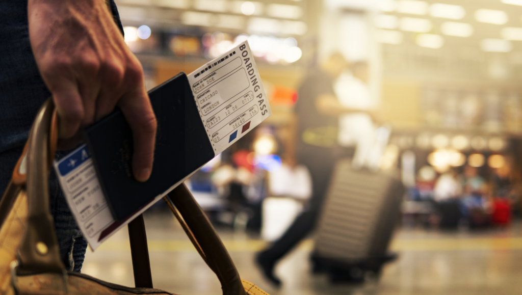 Someone holding a boarding pass in an airport