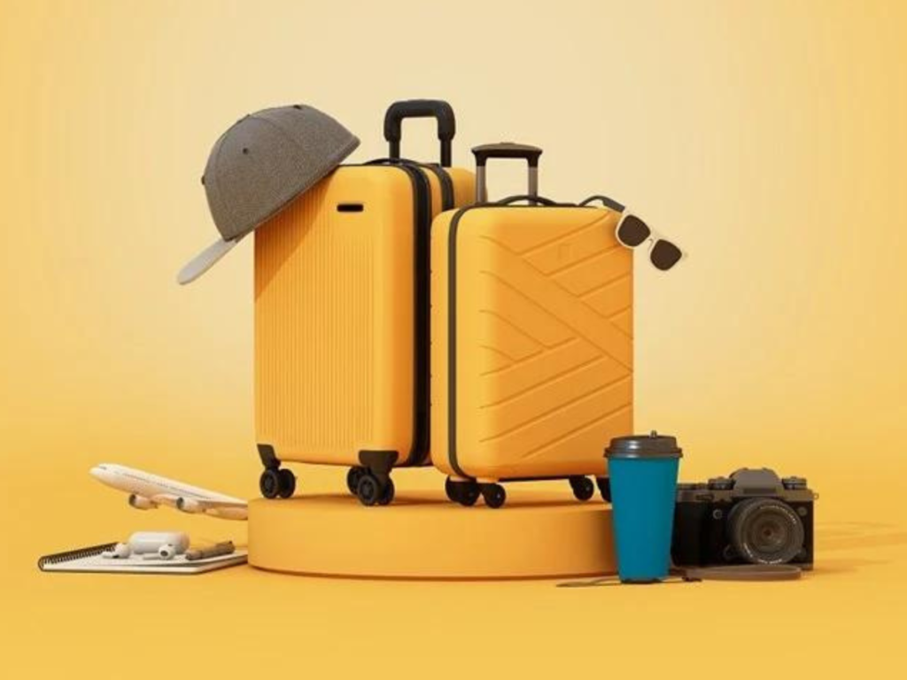 Yellow luggage with travel essentials around it