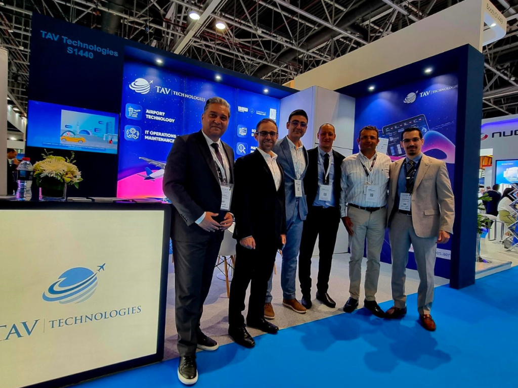 The TAV Technologies team standing by their booth at the Dubai Airport Show