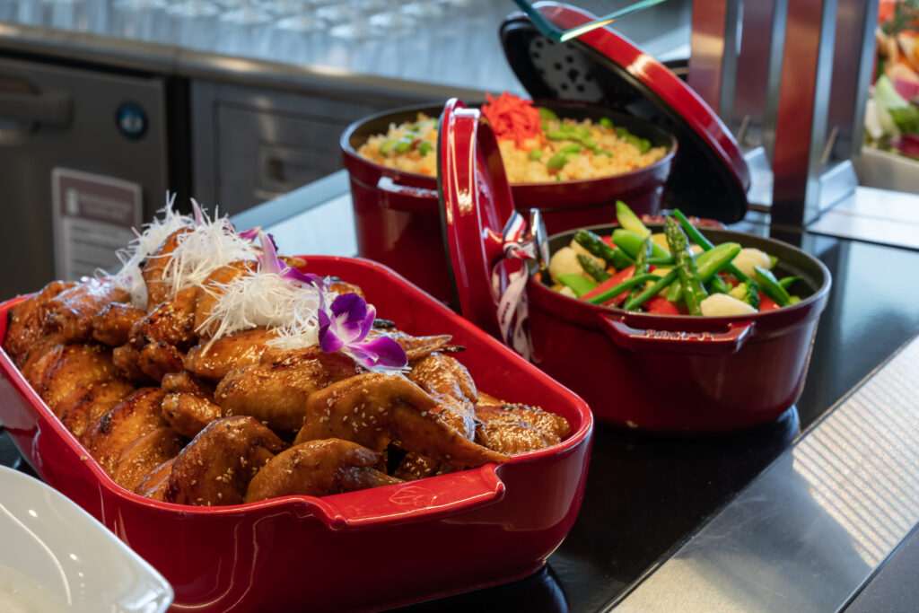 A variety of colourful asian cuisine in red pots