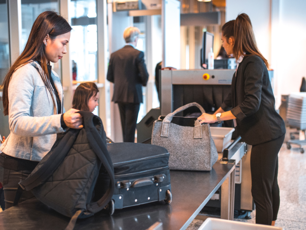 A woman going through a baggage scanner at an airport