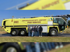 An image of a group of people standing infront of an Oshkosh Striker, a fire suppression vehicle in bright yellow