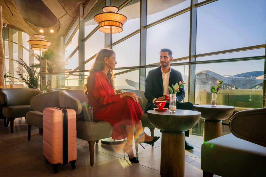 A couple sitting in a stylish airport lounge