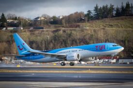 An image of a blue TUI passenger plane taking off from the runway