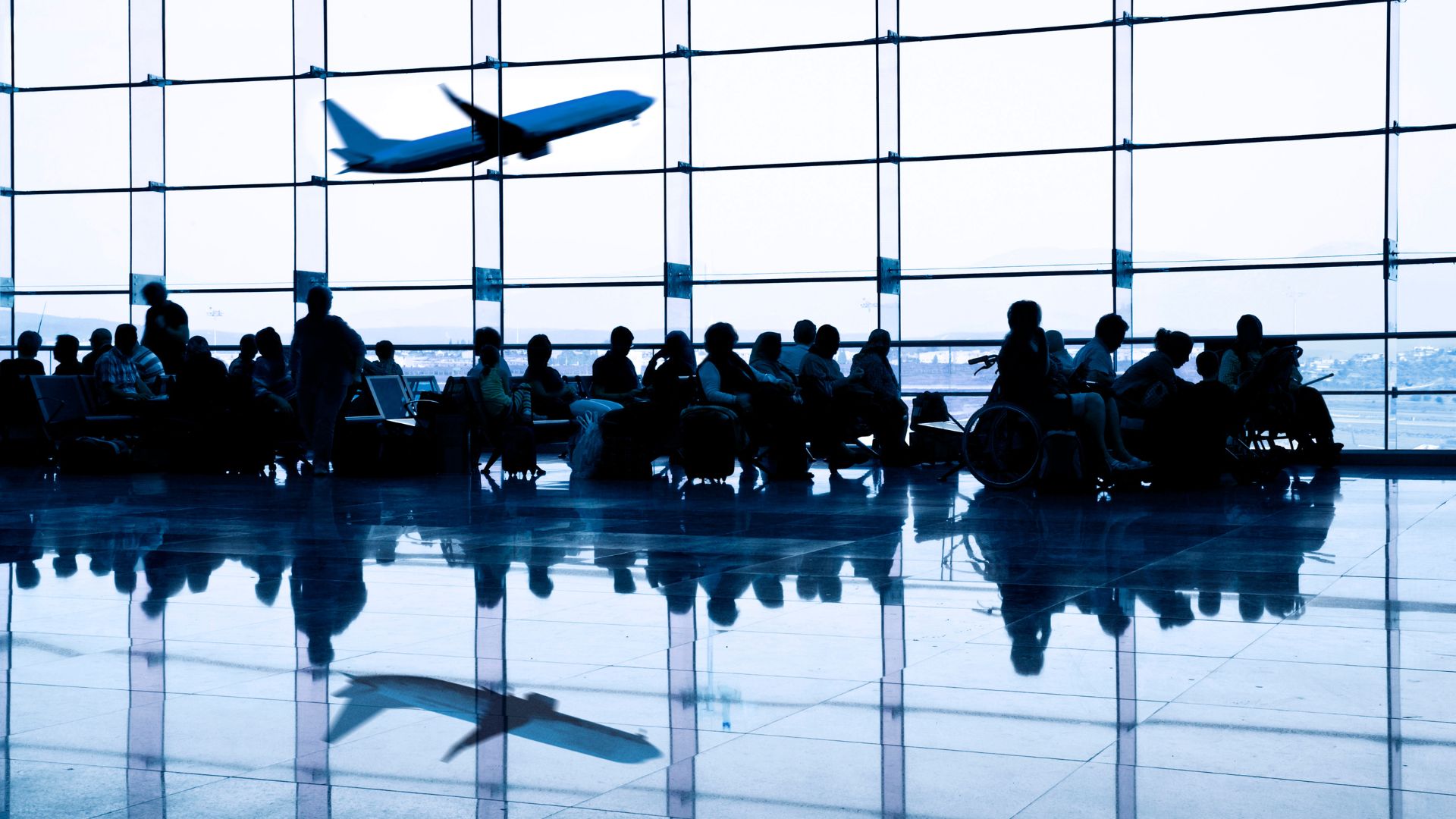 Passengers sitting at an airport terminal 