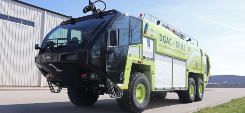 A green and black ARFF vehicle parked at an airport