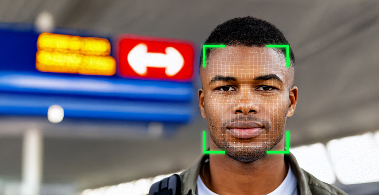 A man facing the camera, with a facial recognition green square imposed over his face