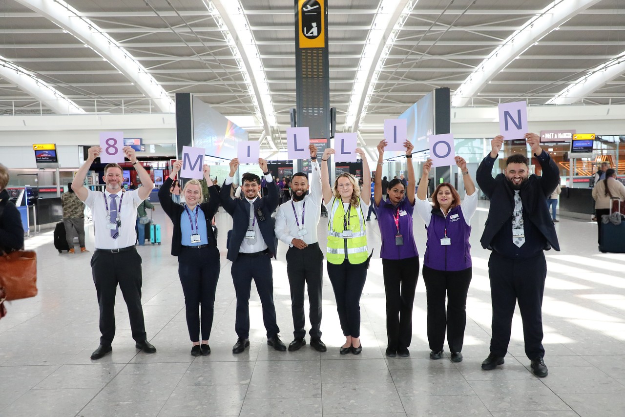 A series of people holding up a set of signs that read 8 MILLION