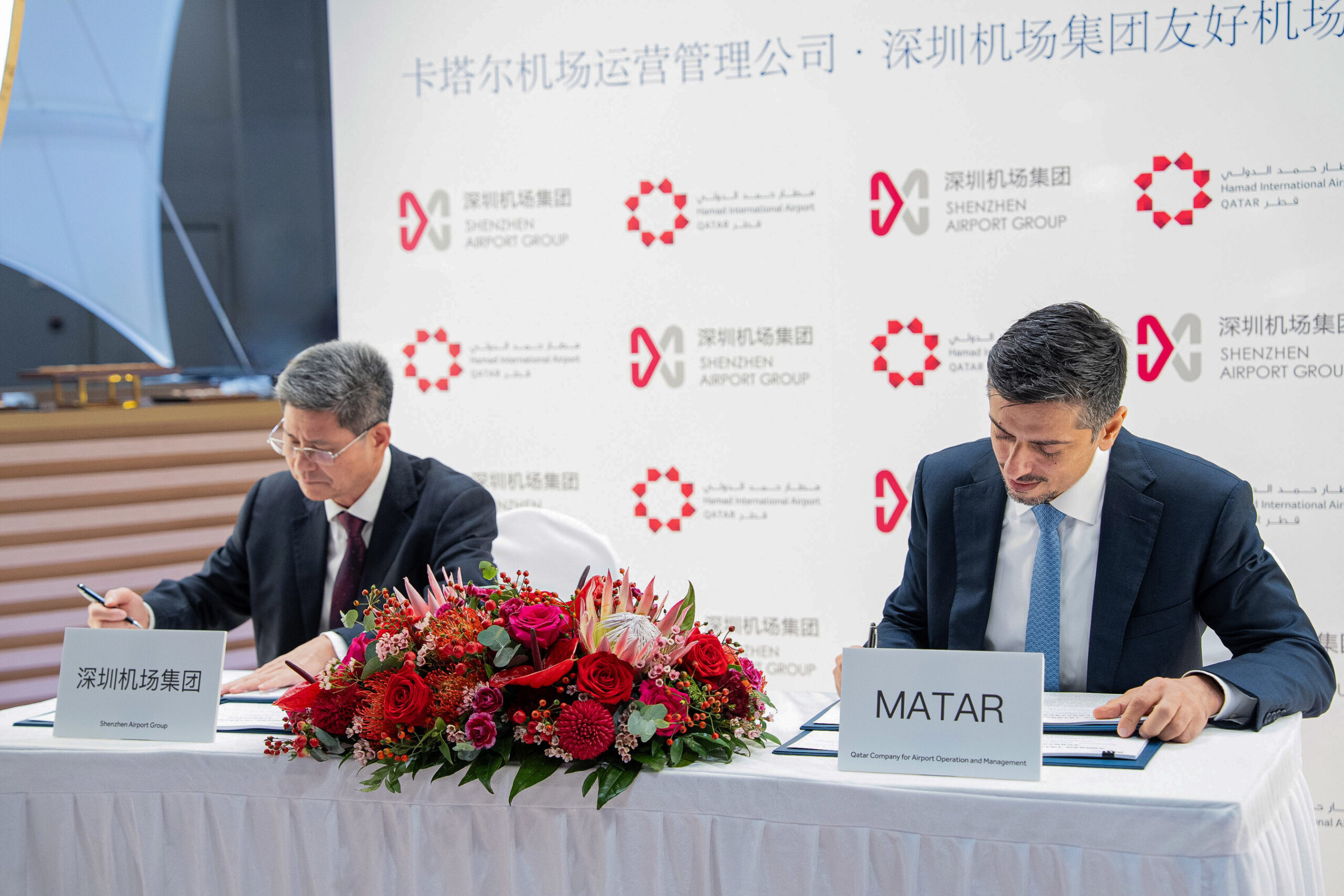 Two men signing an agreement
