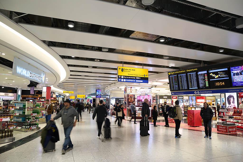 Travellers walking through London Heathrow Airport