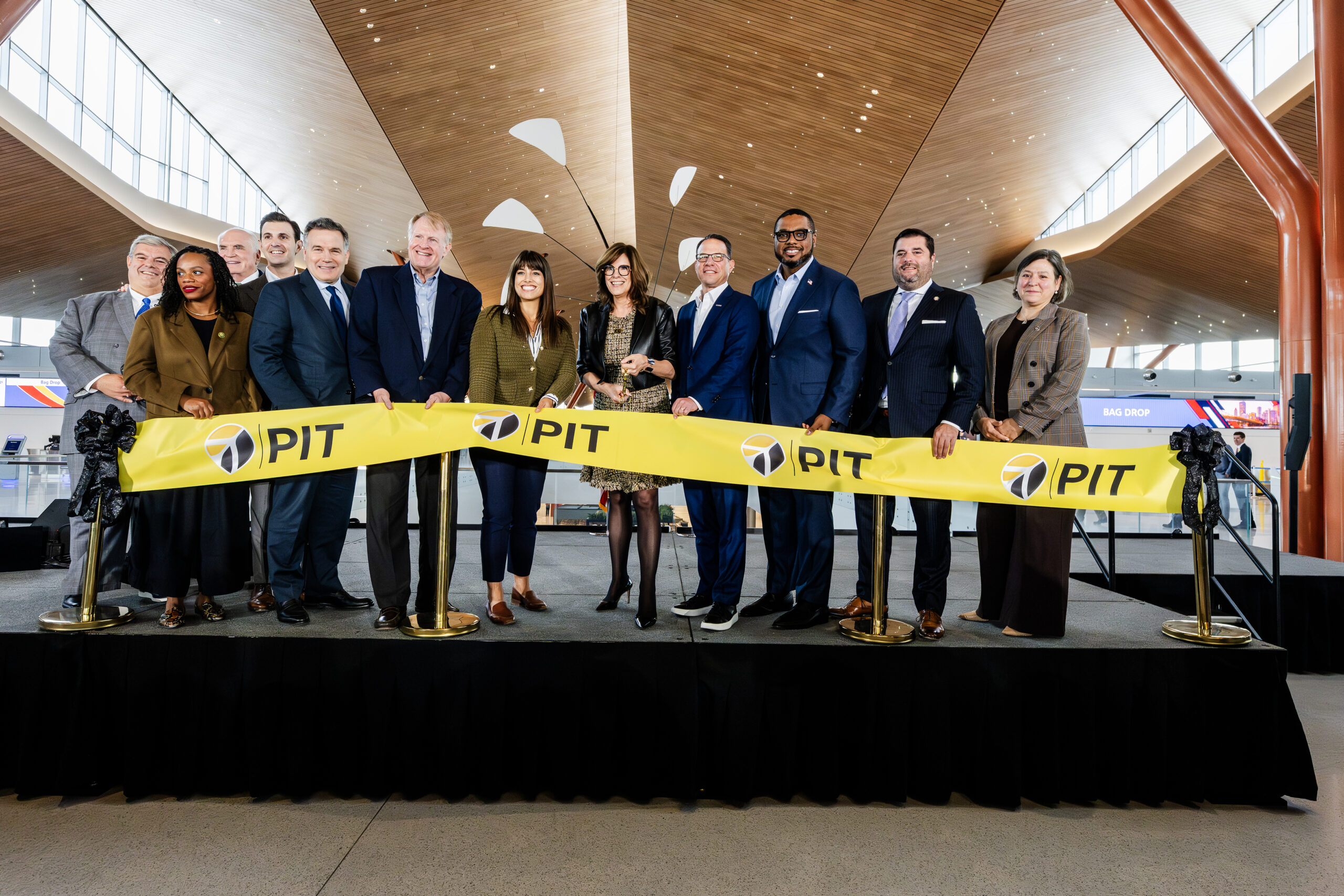 A group of people cutting a ceremonial ribbon