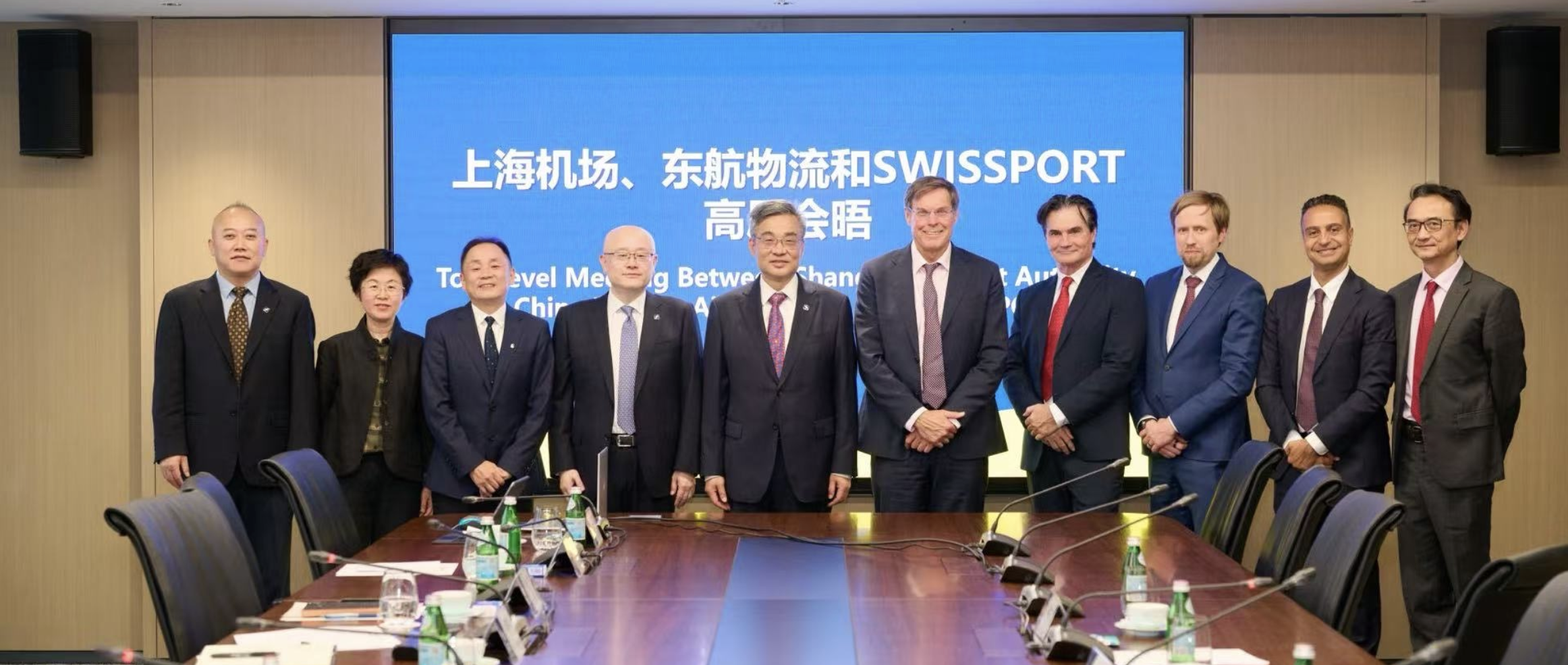 A group of people stood in front of a screen