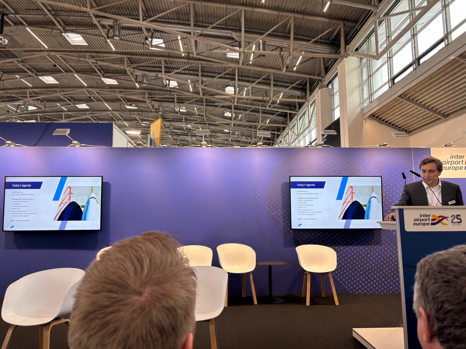 A man stood in front of a screen giving a presentation