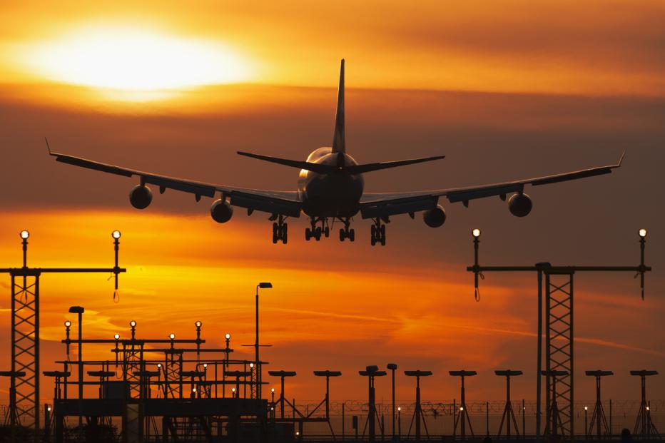 A plane taking off against an evening sky