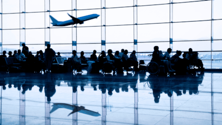 People seated and waiting at a boarding gate