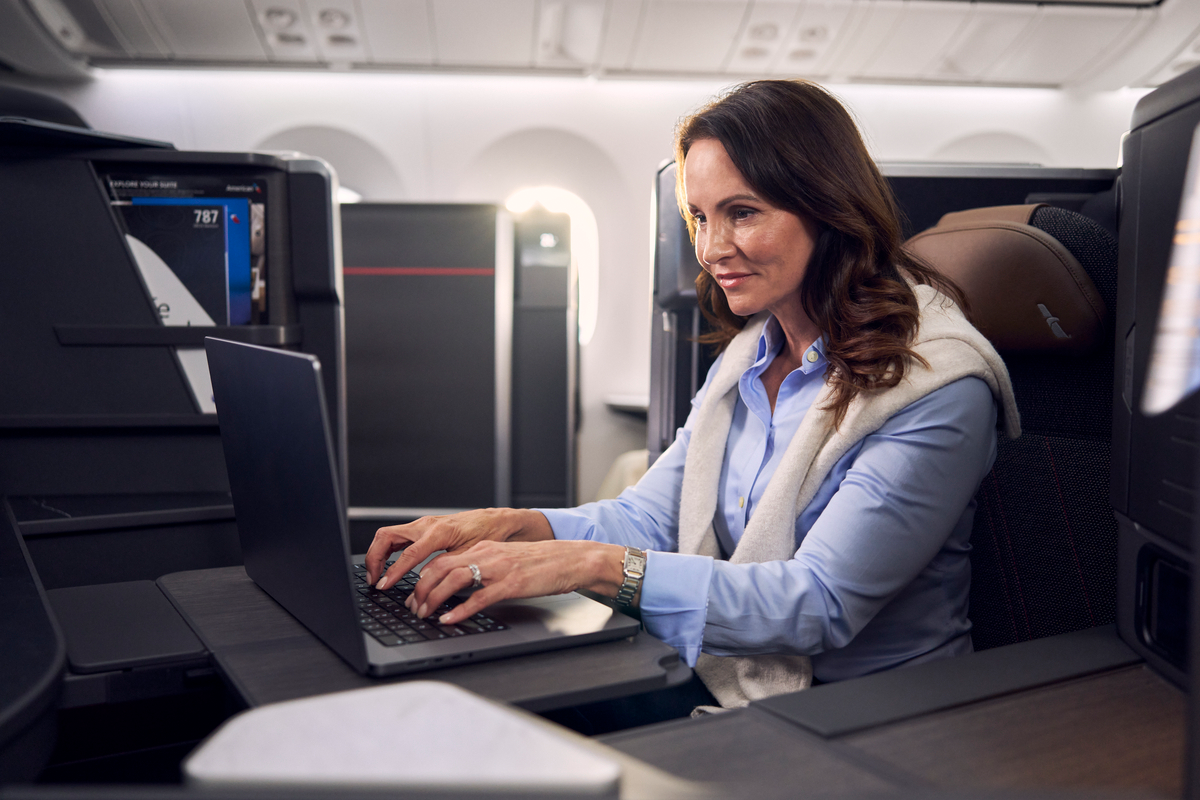 A woman using a laptop on a flight