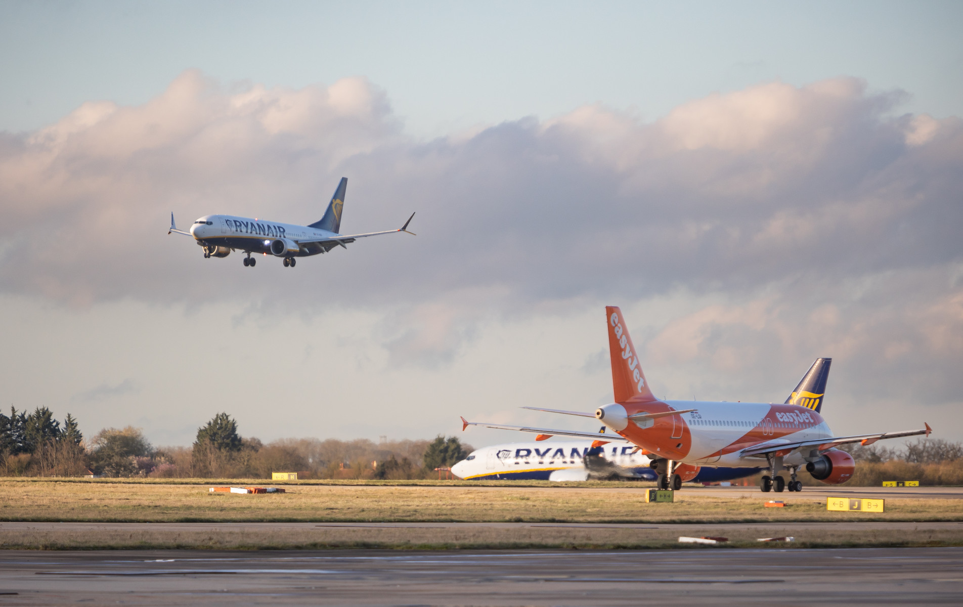 Multiple planes, one flying, two on the ground