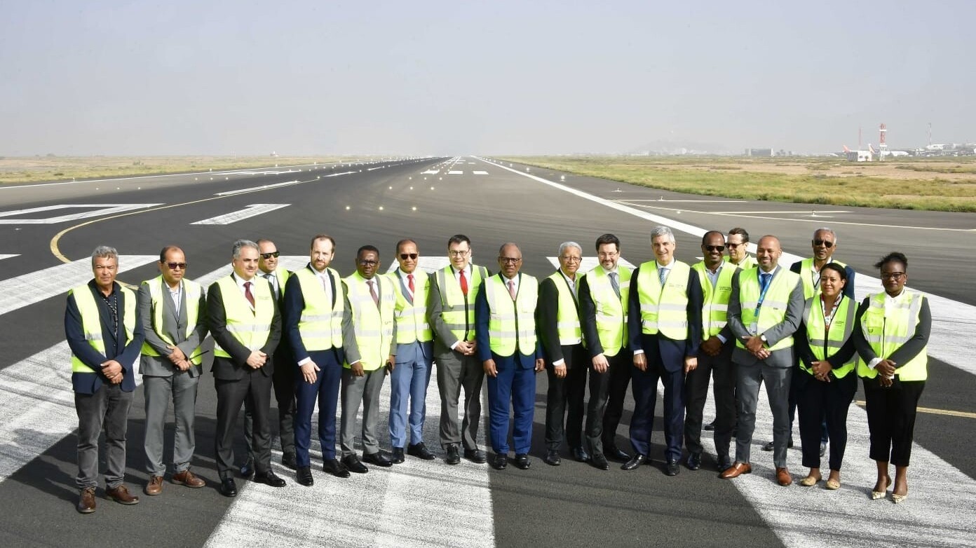 A group of people in high-visibility jackets stood on a runway