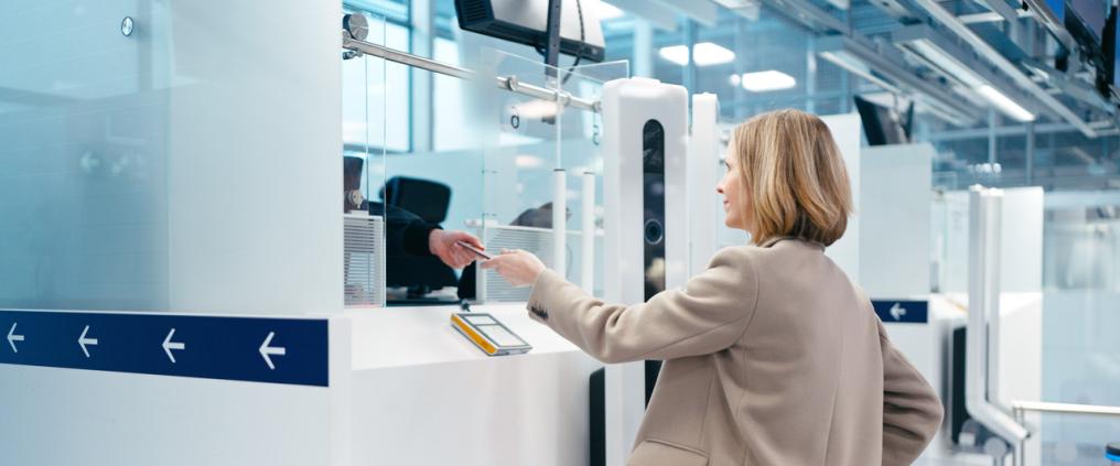 A woman showing her passport at border control