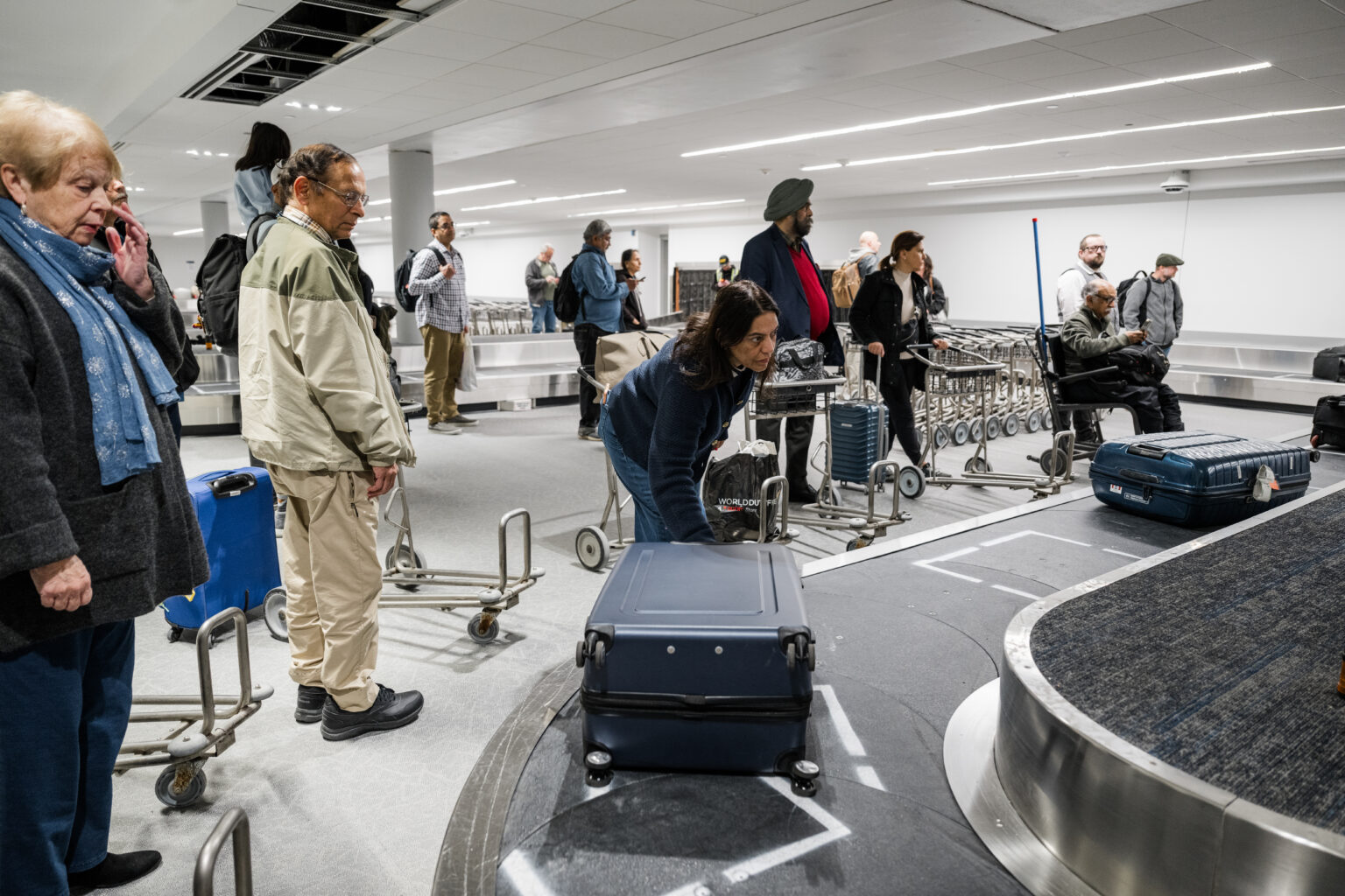 Passengers pick up their checked bags from PIT’s renovated international baggage handling system