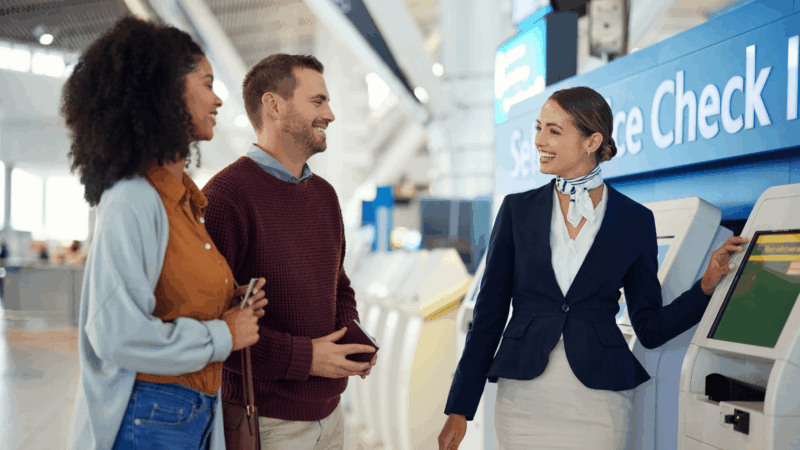Image of customers chatting with air hostess at check in desk