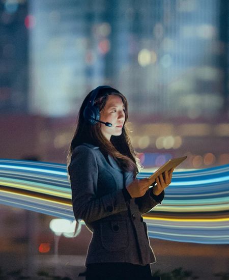 Lady looking at phone with headset on her head