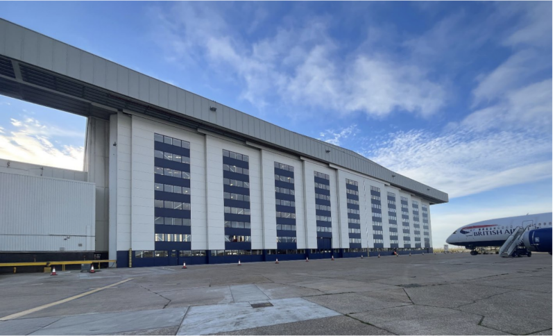 hangar door and nose of a british airways plane on tarmac