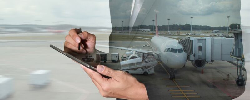 image of person using tablet with background overlay of airport tarmac