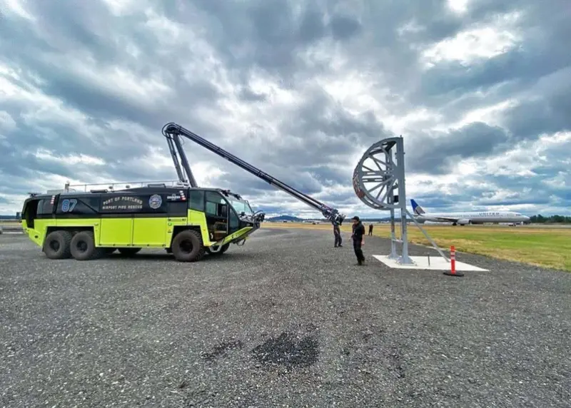 A Striker 6x6 ARFF parked outside on a cloudy day with the Snozzle High Reach Extendable Turret extended