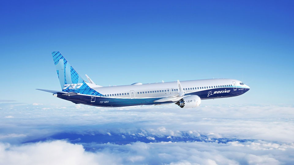 Boeing 737 MAX 10 aircraft in flight above clouds