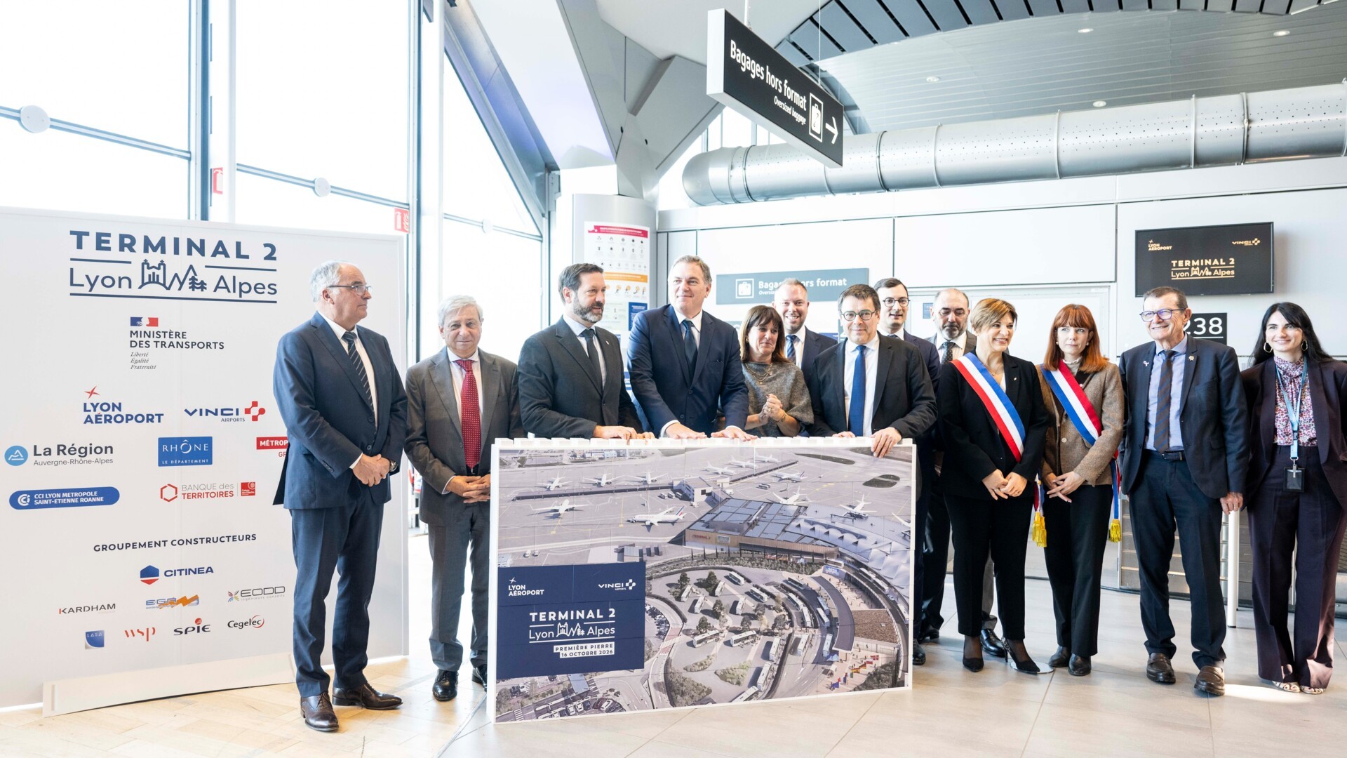 Officials stood by a large planning sign