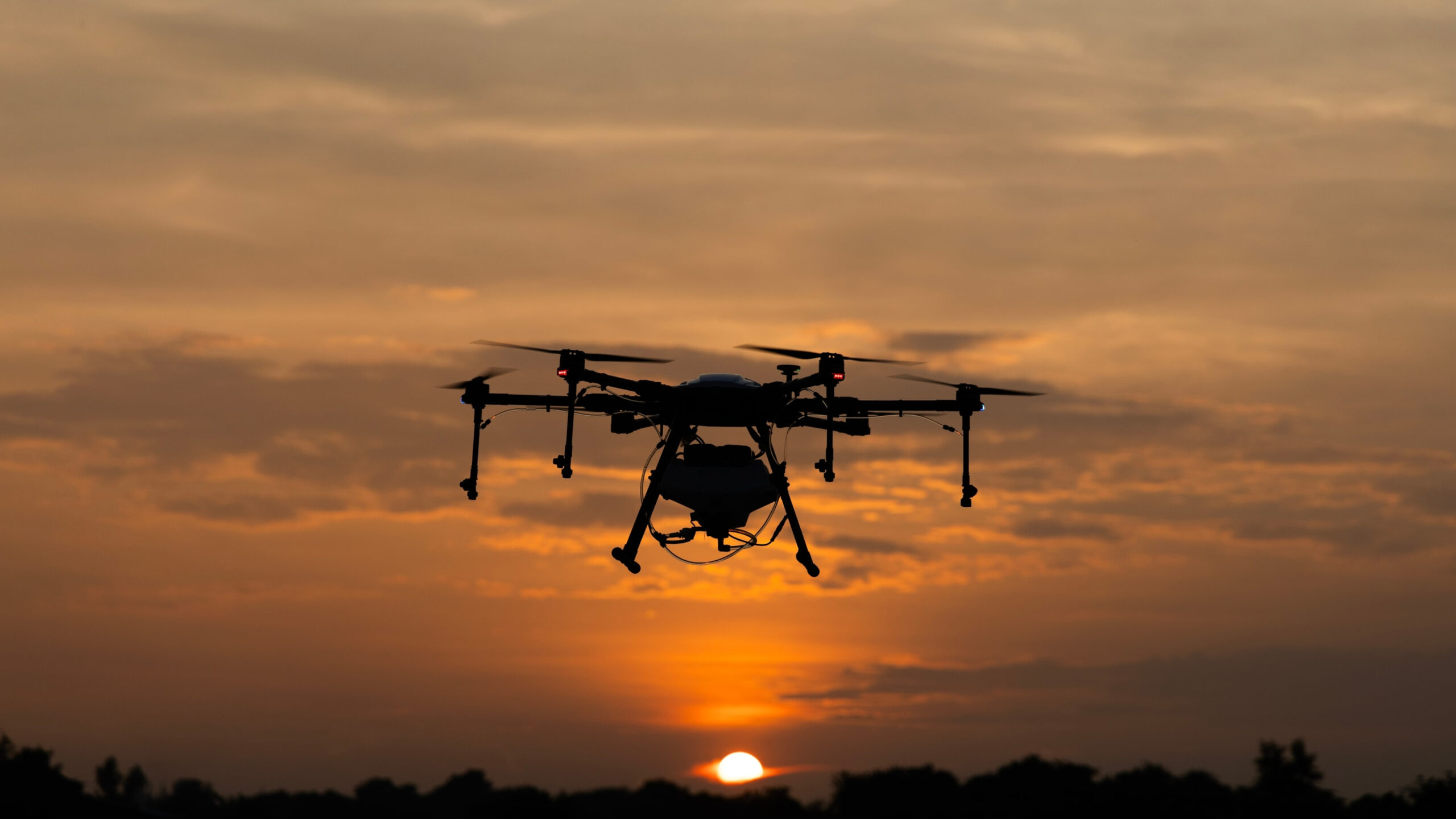 Drone flying at sunset